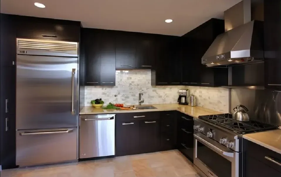 A kitchen with stainless steel appliances and black cabinets