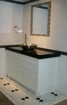 A bathroom with a sink and a mirror on the wall