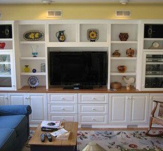 A living room with white cabinets and a flat screen tv
