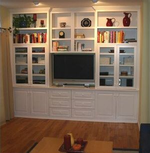 A living room filled with books and a flat screen tv
