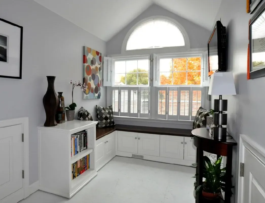 A living room with a vaulted ceiling and lots of windows