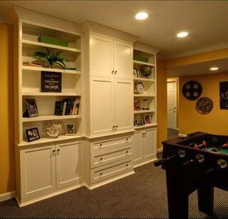 A game room with lots of shelves and a pool table