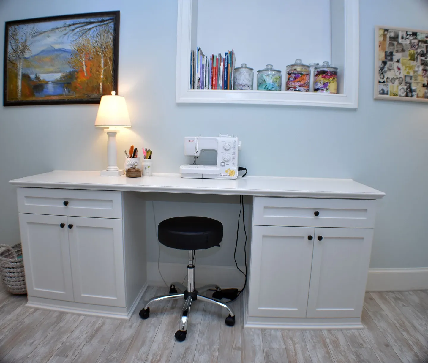 A white desk with a sewing machine on it
