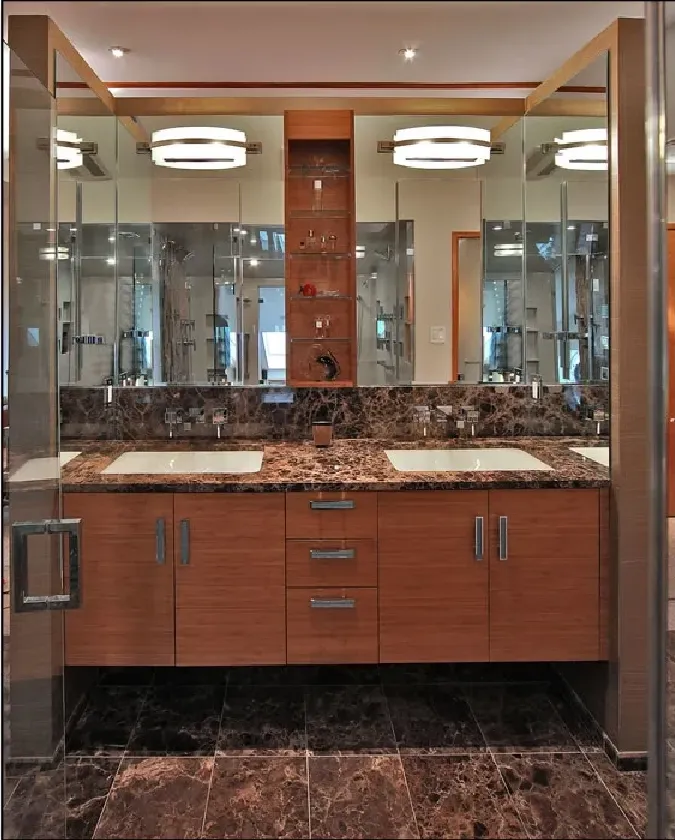 A bathroom with two sinks and a large mirror