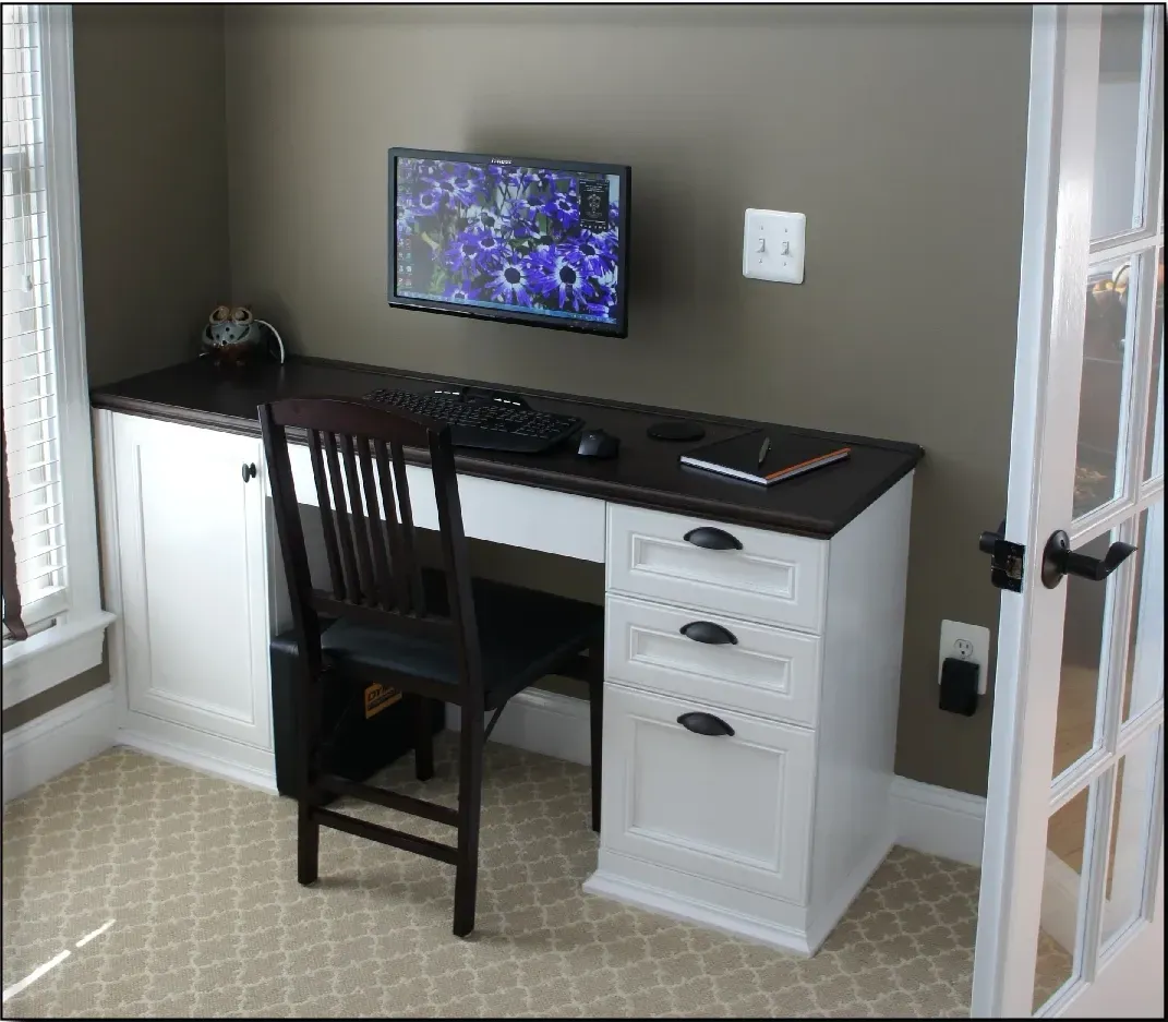 A desk with a chair and a monitor on it