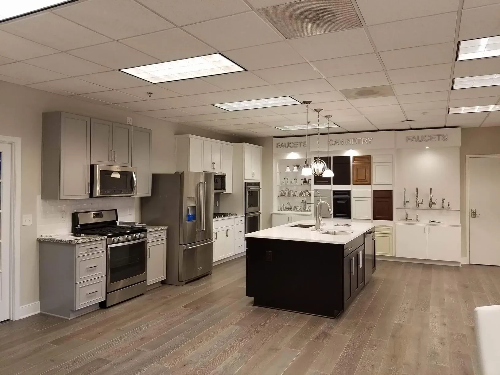 A kitchen with stainless steel appliances and white cabinets