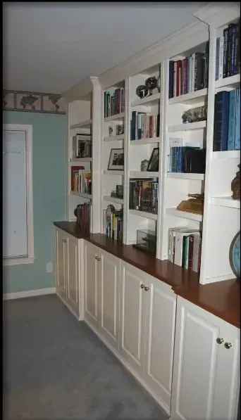 A bookcase with a globe on top of it