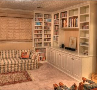 A living room filled with furniture and bookshelves