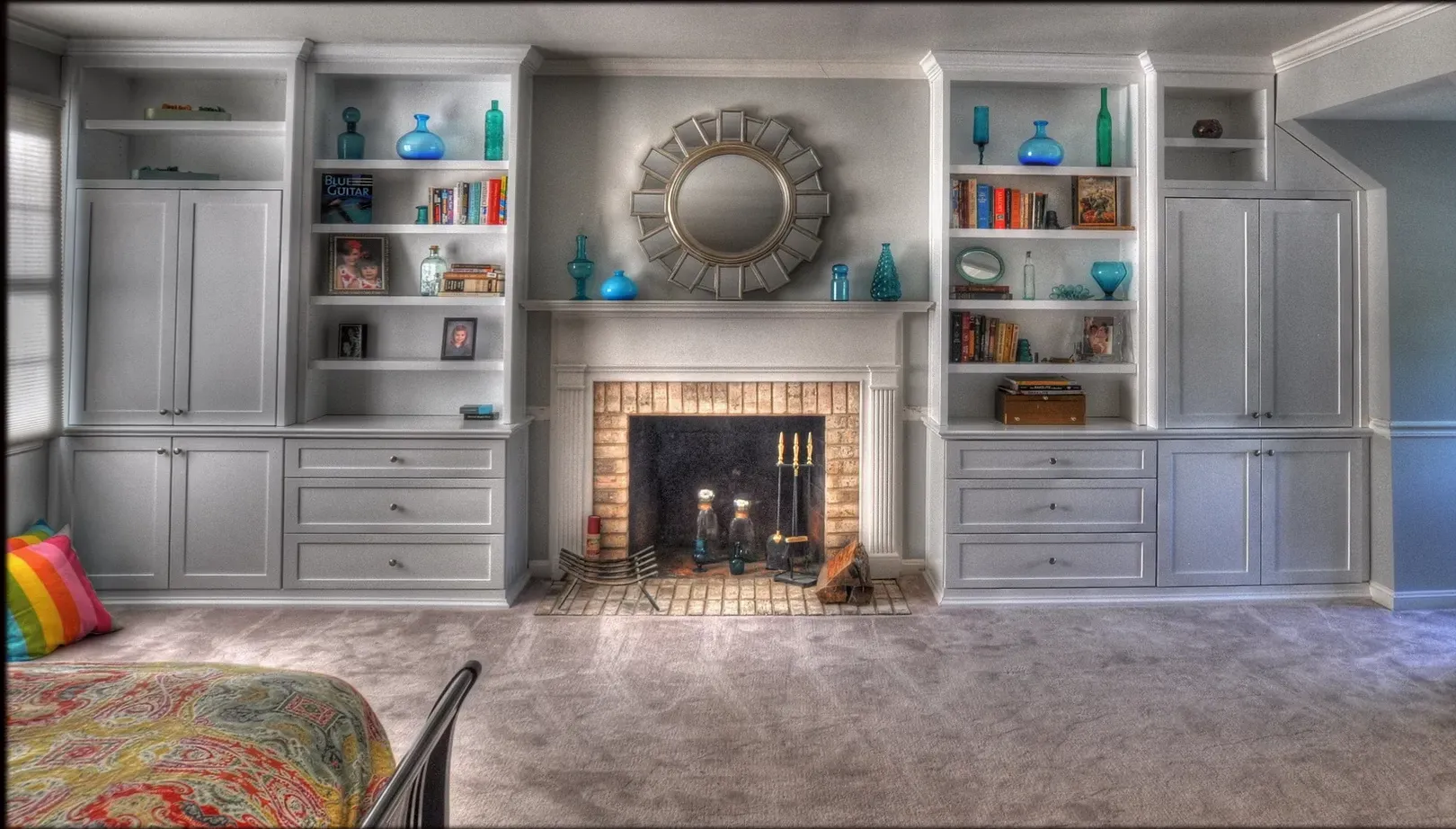 A bedroom with a fireplace and lots of shelves