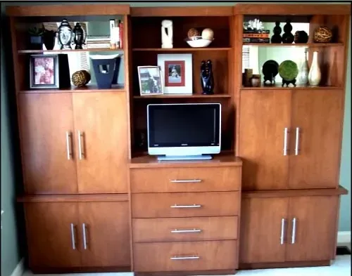 A wooden entertainment center with a flat screen tv