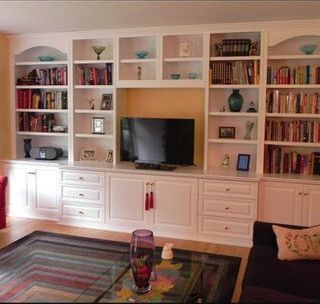 A living room with bookshelves and a flat screen tv