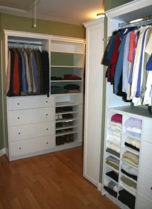 A walk in closet filled with lots of clothes