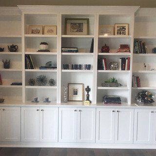 A bookshelf with lots of books and pictures on it