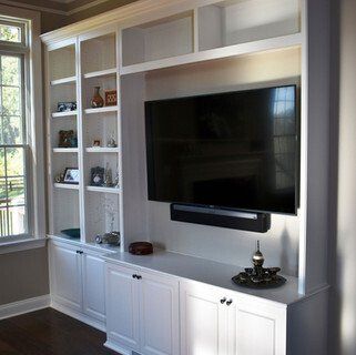 A living room with a large flat screen tv on the wall