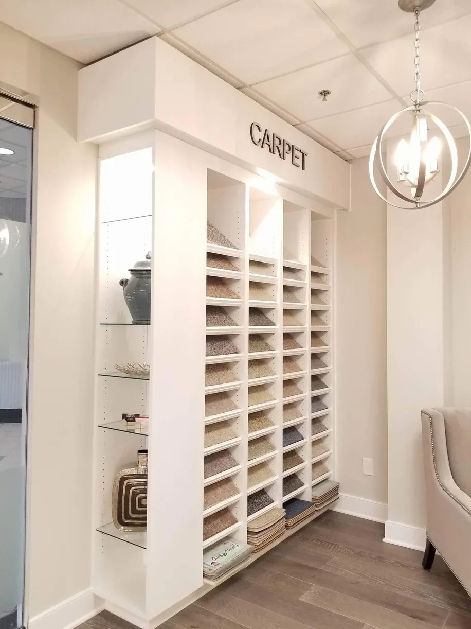 A room with a lot of shelves and a chandelier hanging from the ceiling.