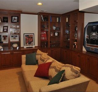 A living room with a couch and a television with a hockey jersey on it