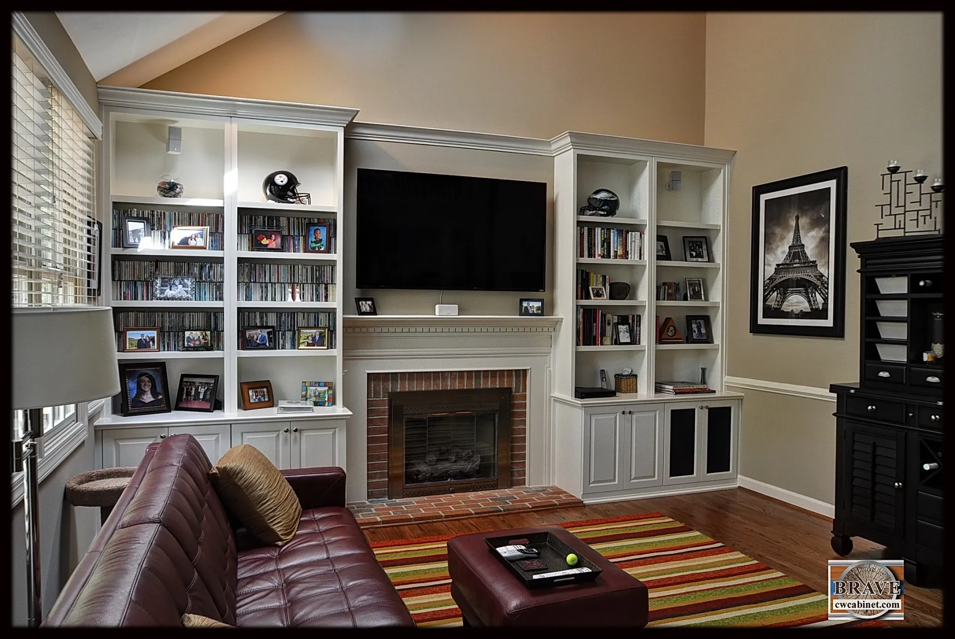A living room with a fireplace and a flat screen tv