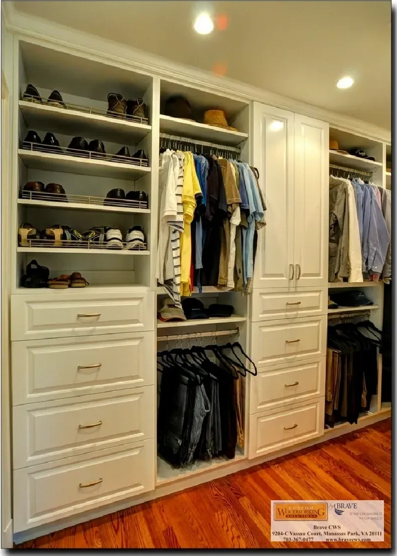A walk in closet with lots of clothes and shoes