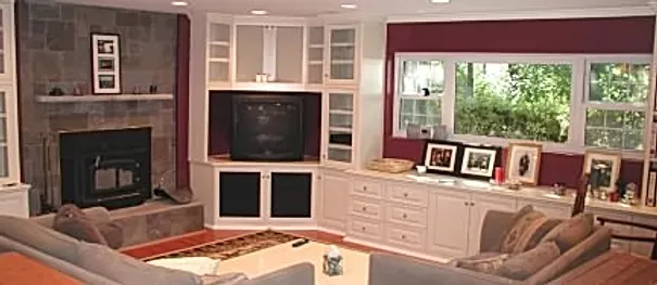 A living room with a couch , fireplace and television.