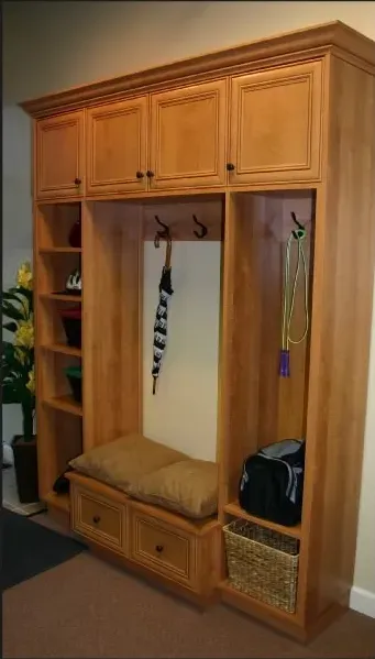 A wooden closet with a bench and baskets