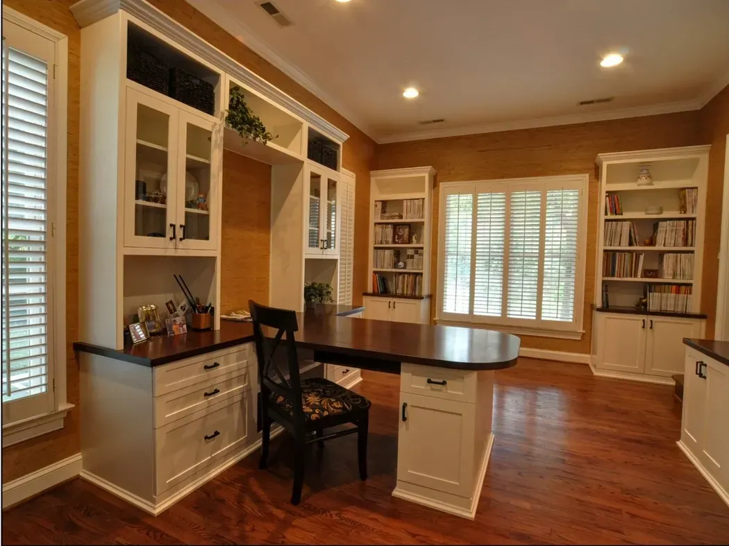 A home office with lots of cabinets and shelves