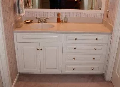 A bathroom vanity with a sink and a mirror.