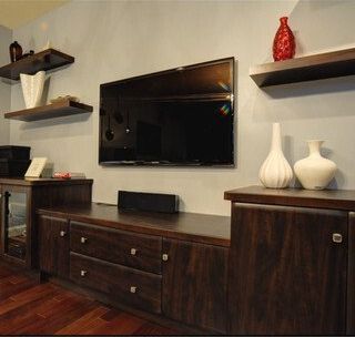 A living room with a flat screen tv on the wall