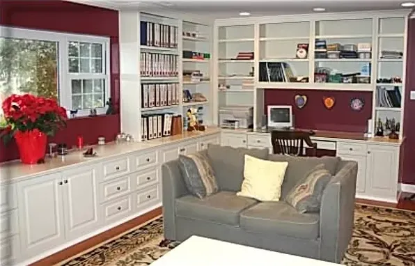 A living room with a couch and lots of shelves