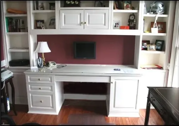 A home office with a desk and a lamp