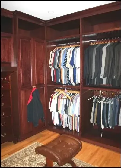 A walk in closet filled with lots of clothes