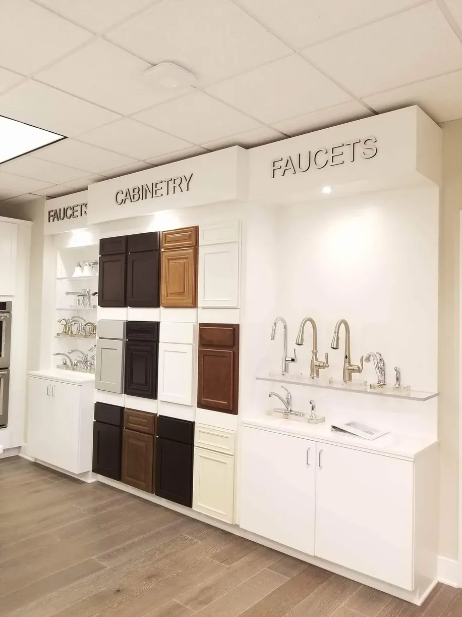 A kitchen with lots of cabinets and faucets on display