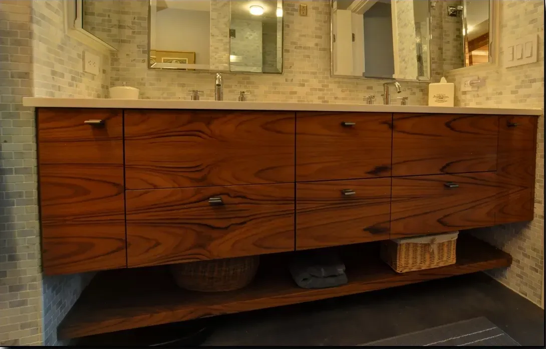 A bathroom with two sinks and a wooden vanity