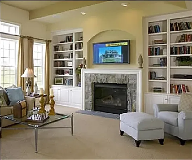 A living room with a fireplace and a flat screen tv