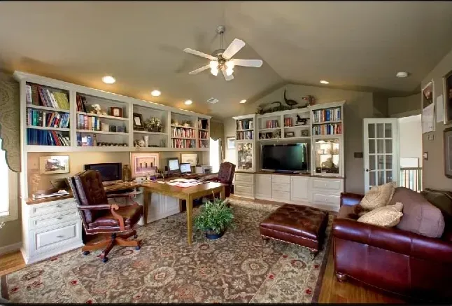 A living room filled with furniture and a ceiling fan