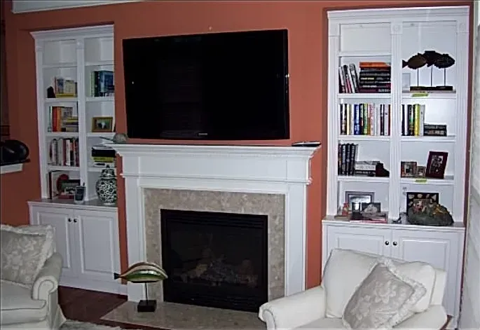 A living room with a fireplace and a flat screen tv