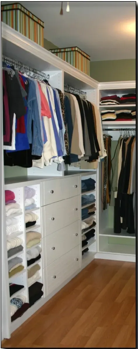 A walk in closet filled with clothes and boxes