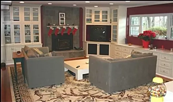 A living room with a fireplace and stockings on the mantle