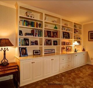 A living room with lots of shelves and a lamp