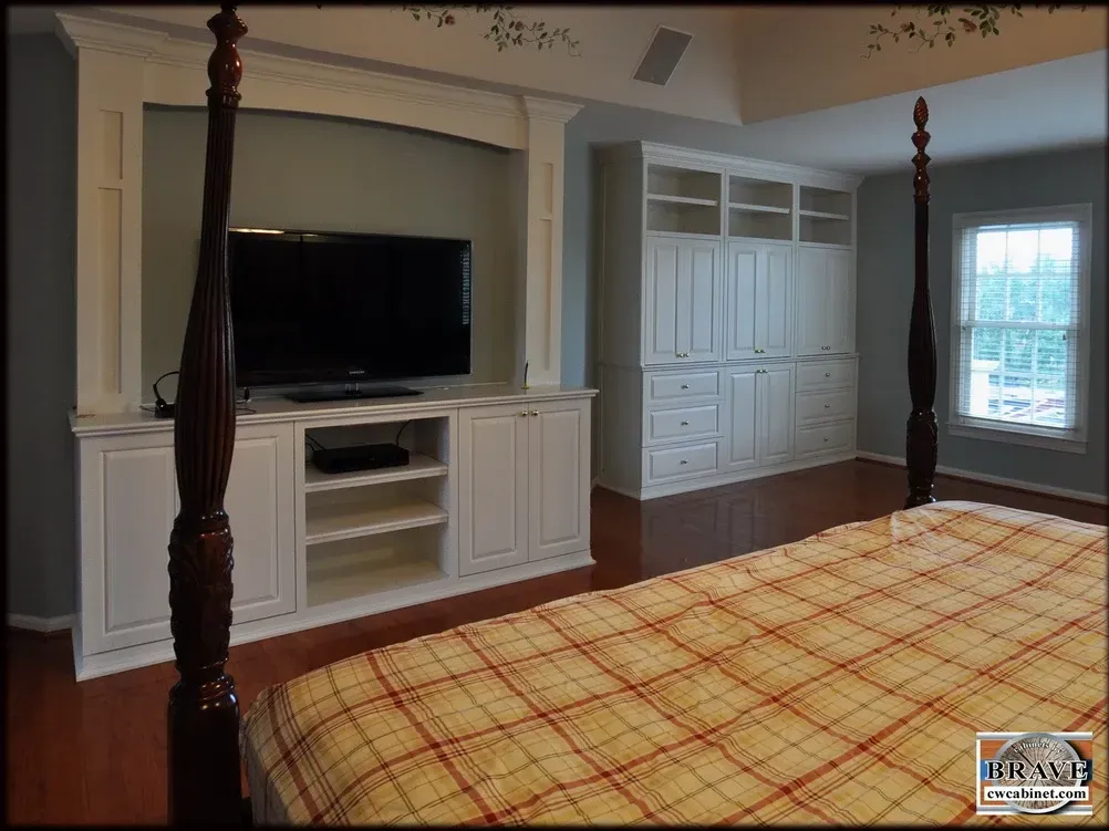 A bedroom with a four poster bed and a flat screen tv
