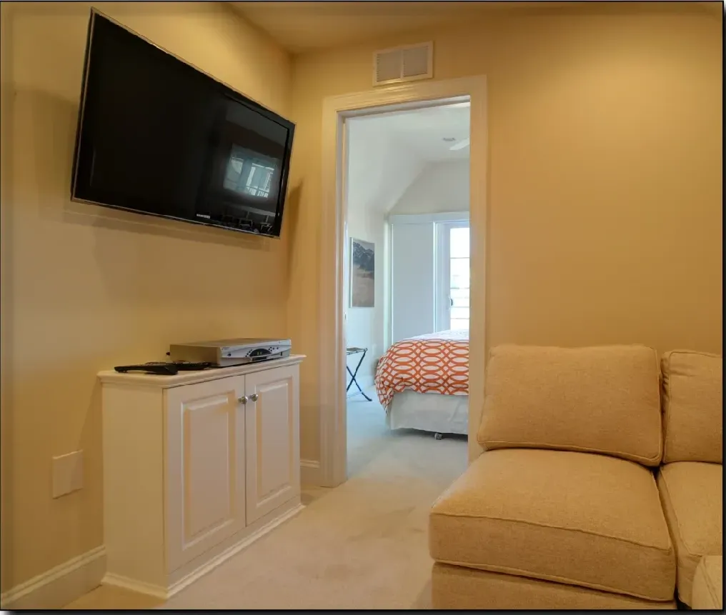 A living room with a couch and a flat screen tv
