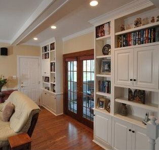 A living room with a couch and lots of bookshelves