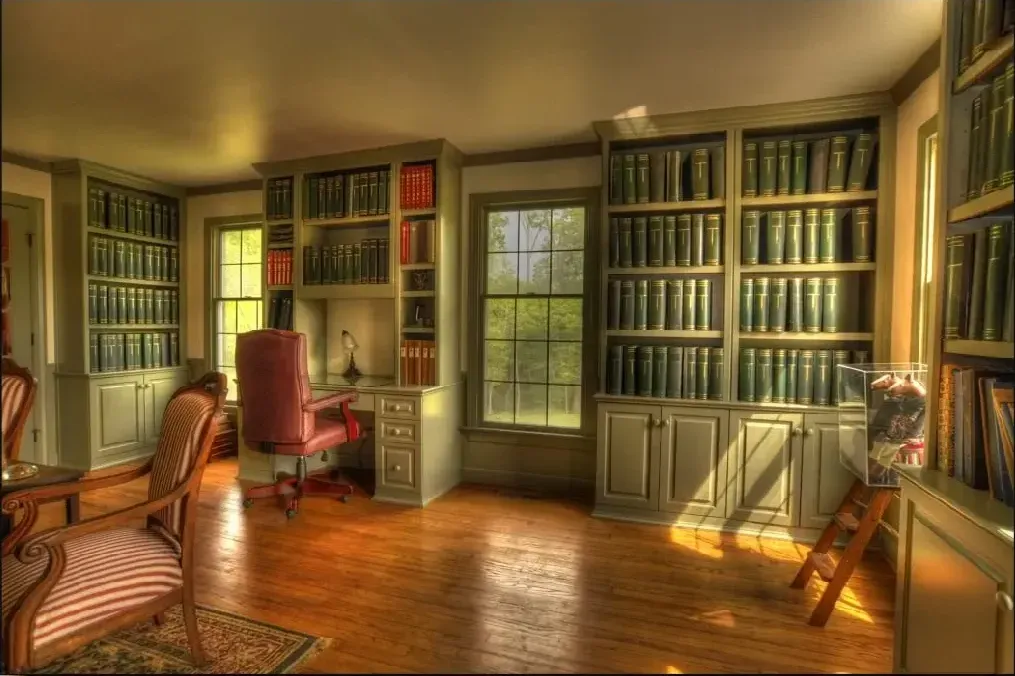 A room with a lot of books on the shelves