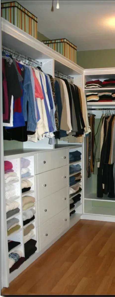 A walk in closet filled with clothes and boxes