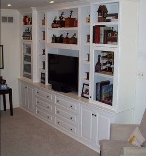 A living room with white cabinets and a flat screen tv