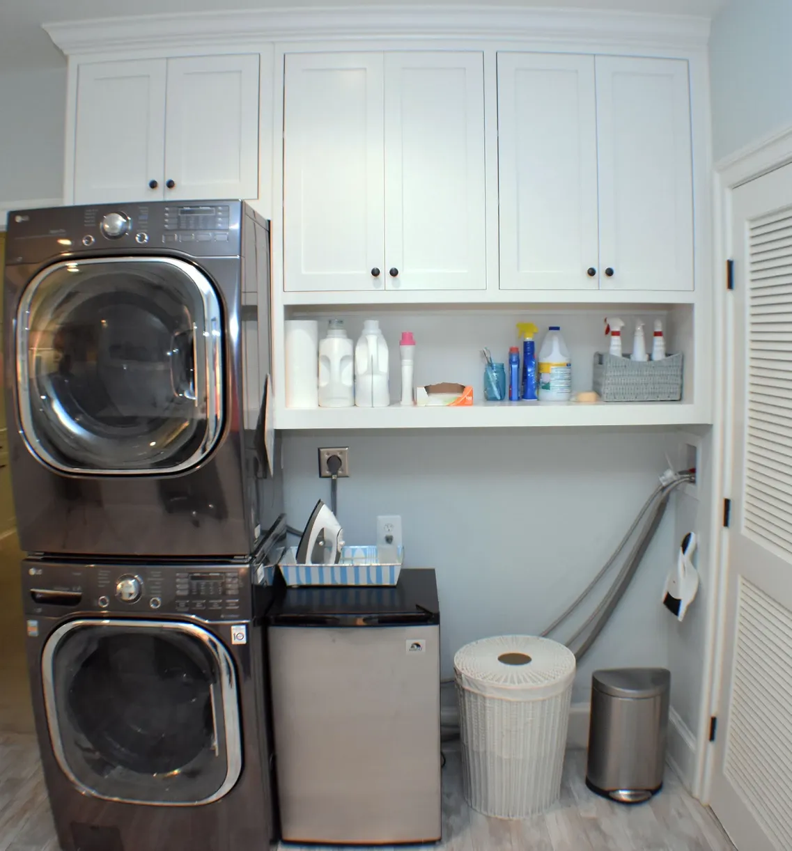 A laundry room with a washer and dryer stacked on top of each other