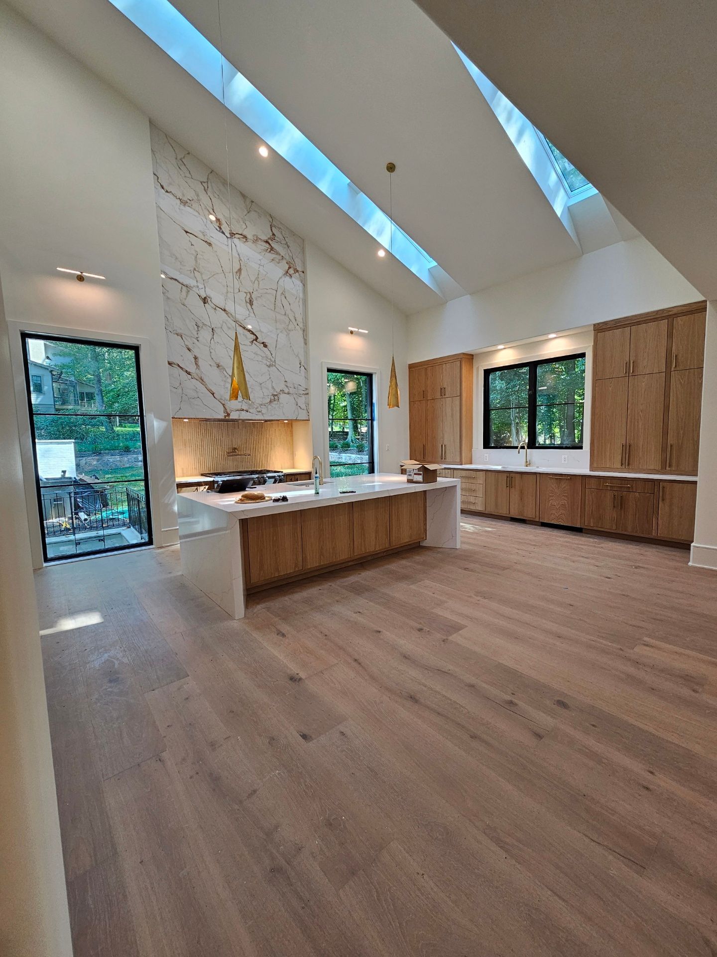A kitchen with wooden cabinets and a skylight in the ceiling
