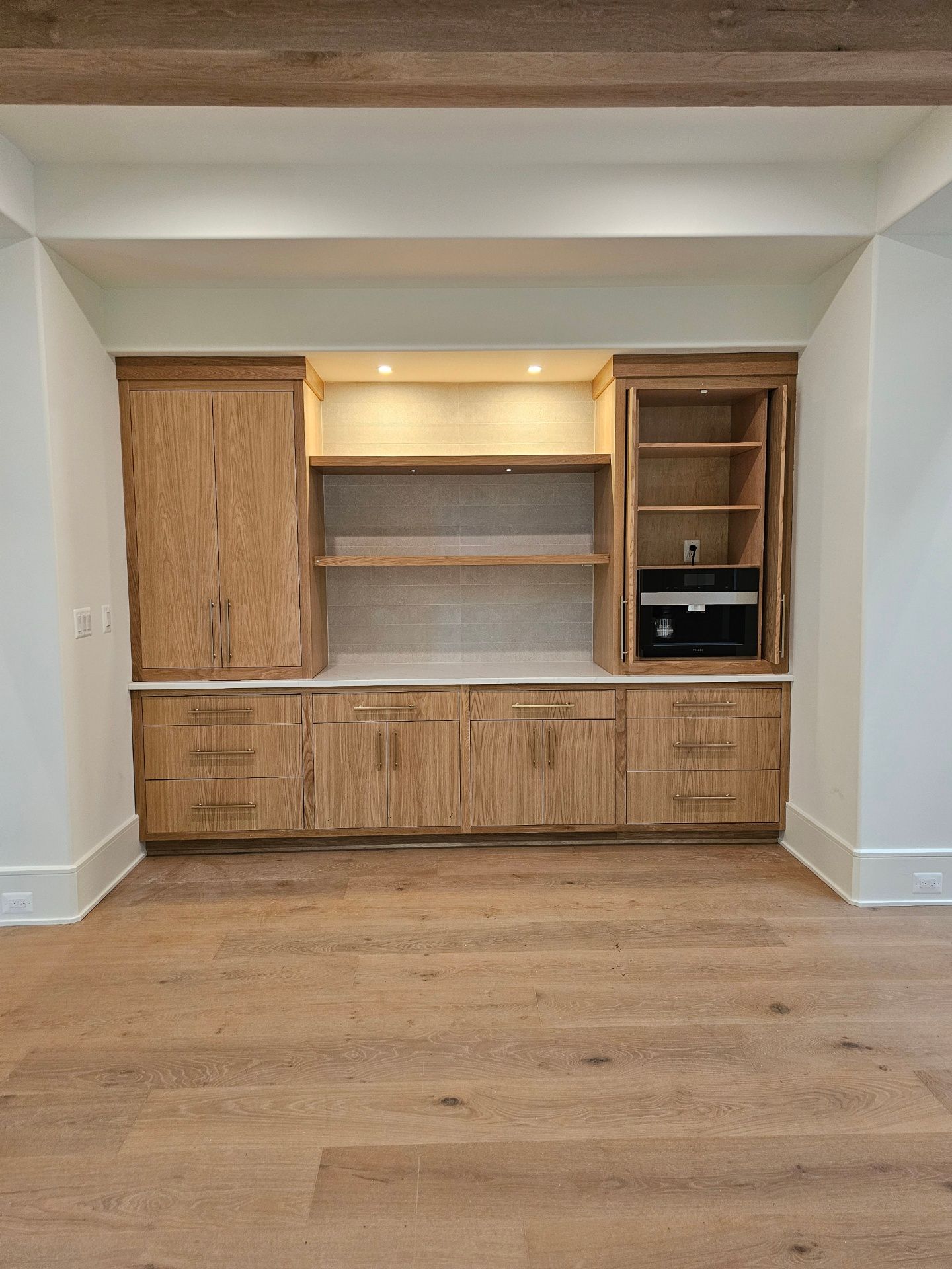 A kitchen with wooden cabinets and white counter tops