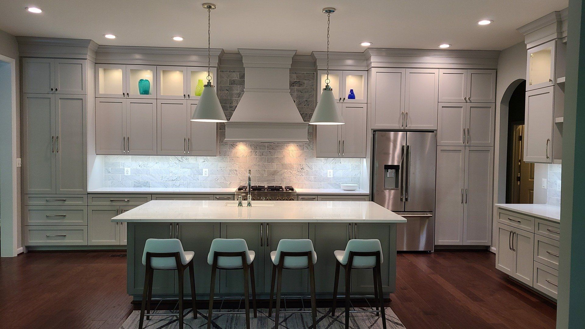 A kitchen with white cabinets and stainless steel appliances