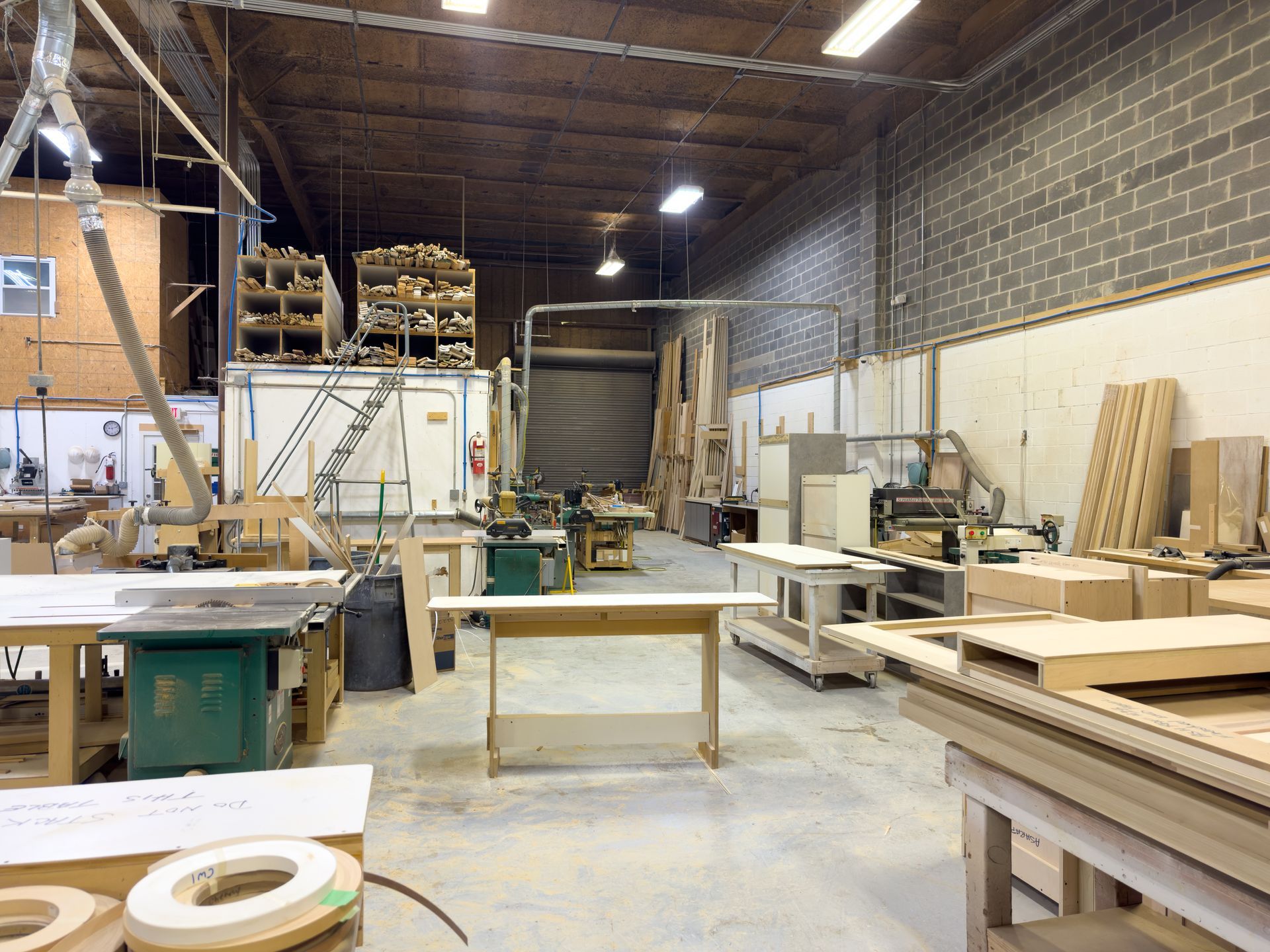A large warehouse filled with lots of woodworking equipment
