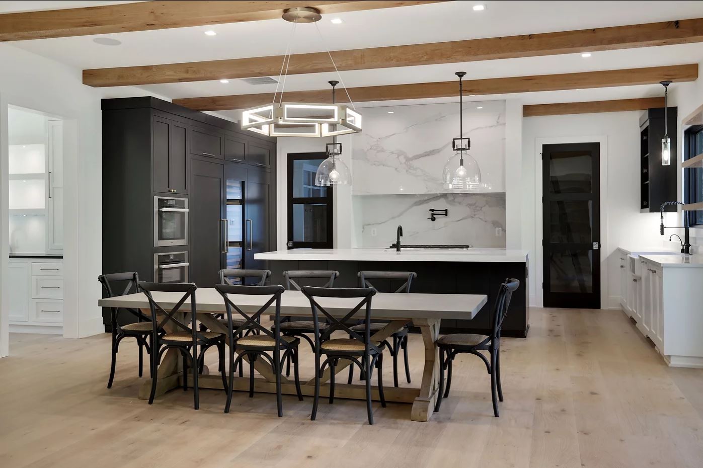 A kitchen with a large dining table and chairs